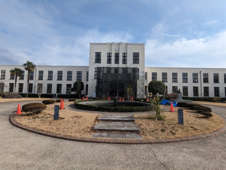 豊郷小学校旧校舎群の正面と円形の花壇（2024年2月、玄関に工事の足場がある）