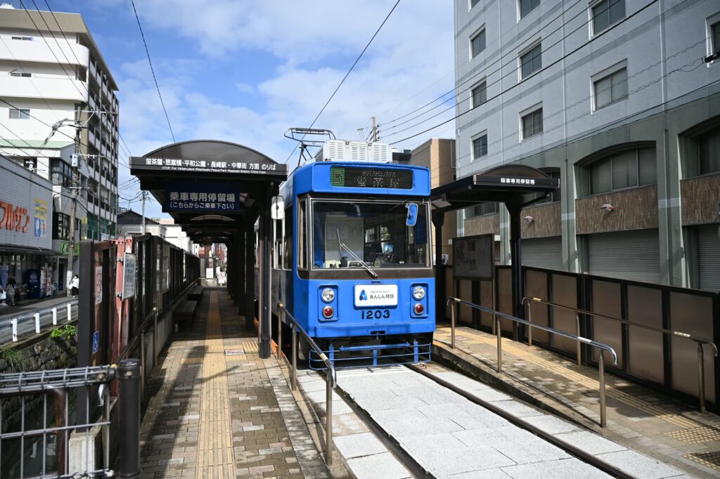 長崎の路面電車・石橋電停に止まる青い電車。グラバースカイロードの乗り場の近く